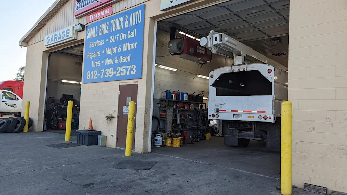 Garage bays open with a service truck inside